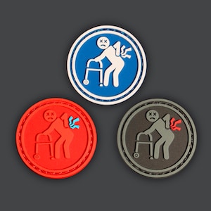May include: Three round patches with a white stick figure of a person with a walker and a red or blue pain symbol on their back. The patches are blue, red, and gray.