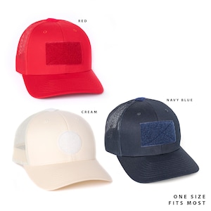 May include: Three baseball caps in red, cream, and navy blue. Each cap features a mesh back, a solid front panel, and a curved brim. The red and navy blue caps have rectangular hook-and-loop patches, while the cream cap has a circular patch. Text: ONE SIZE FITS MOST.