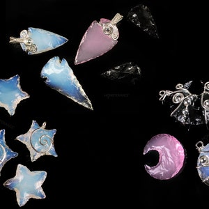 May include: Assortment of handmade gemstone pendants featuring star, crescent moon, and arrowhead shapes. The pendants are made with blue, pink, and black agate and have silver wire wrapping.