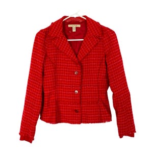 May include: A red tweed blazer with a notched collar, long sleeves, and a button front closure. The blazer has a checkered pattern and a frayed hem.