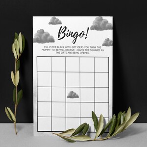 May include: A black and white Bingo game card with cloud illustrations. The word "Bingo!" is written in a script font. The card has a grid of squares and instructions to fill in gift ideas.