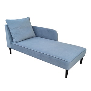May include: A light blue chaise longue with a matching cushion and black wooden legs.
