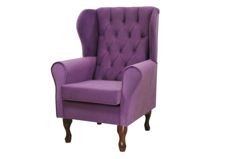 May include: A purple wingback armchair with a tufted back and seat. The chair has wooden legs and a classic design.