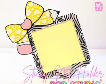 May include: A decorative sticky note holder with a yellow bow and pencil design. The bow has a heart pattern. The holder has a zebra print border and a yellow sticky note. Text on the image says "3D PRINT FILE" and "Sticky Note Holder".