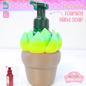 May include: A decorative hand soap dispenser featuring a green and yellow succulent design. The dispenser is in a brown pot-shaped base and has a green pump. Text on the image reads "Fits BBW Foaming Hand Soap."