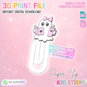 Puede incluir: Un archivo de impresión 3D para un clip de papel de fantasma blanco con un lazo rosa, sosteniendo un libro rosa con un corazón y un vaso rosa. La descarga digital incluye archivos 3MF y STL. El texto incluye 3D PRINT FILE, INSTANT DIGITAL DOWNLOAD, DIGITAL FILE ONLY, NO PHYSICAL ITEM, NO SUPPORTS, Paper Clip y B3D STUDIO.