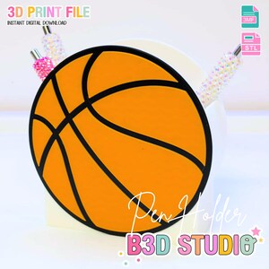 May include: A basketball-themed pen holder with an orange and black design. The pen holder is in the shape of a basketball, with black lines outlining the ball's panels. The text "Pen Holder" and "B3D STUDIO" are visible. The image also includes the text "3D PRINT FILE" and "INSTANT DIGITAL DOWNLOAD".