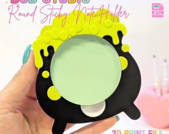 May include: A black cauldron-shaped sticky note holder with bright yellow bubbling liquid dripping from the top rim. The center features a round light green sticky note. Text at the top reads B3D STUDIO Round Sticky Note Holder, with 3MF and STL icons.