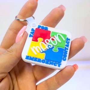 May include: White keychain with a puzzle design featuring the name "Mason" in green, surrounded by red, yellow, and blue puzzle pieces. The keychain has the text "TAP FOR CONTACT EMERGENCY" in blue.
