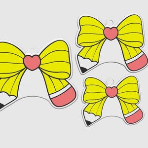 May include: Three yellow bow-shaped pencil charms with a pink heart in the center. The pencils have a white body, black tip, and pink eraser. The charms are on a white background.