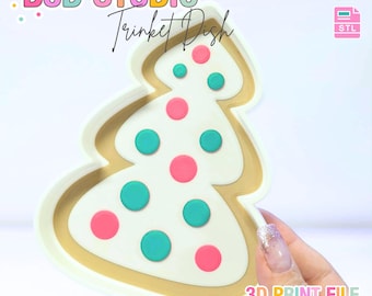 May include: A Christmas tree-shaped trinket dish with a white base, gold trim, and colorful polka dots. The dish has the text "B3D STUDIO Trinket Dish" and "3D PRINT FILE" with "INSTANT DIGITAL DOWNLOAD".