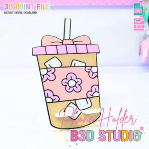 Könnte beinhalten: Ein 3D-gedruckter Telefonhalter in Form eines Cartoon-Getränkebechers. Der Becher ist hellbraun mit einem rosa Blumenband und einer rosa Schleife oben. Der Text "Phone Holder" und "B3D STUDIO" sind sichtbar.
