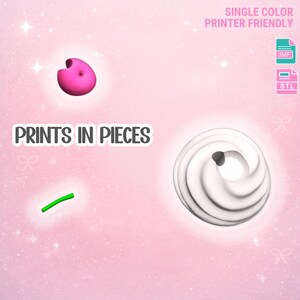May include: A pink, 3D-printed object with a hole, a white swirl, and a green curved line, set against a pink background. The text "PRINTS IN PIECES" is displayed. The image also includes the text "SINGLE COLOR PRINTER FRIENDLY".