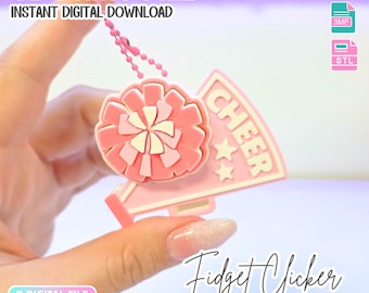May include: A 3D print file for a pink and cream cheerleading-themed fidget clicker. The design features a pom-pom and a megaphone with the text CHEER and two stars. This is an instant digital download for a single color printer-friendly file.