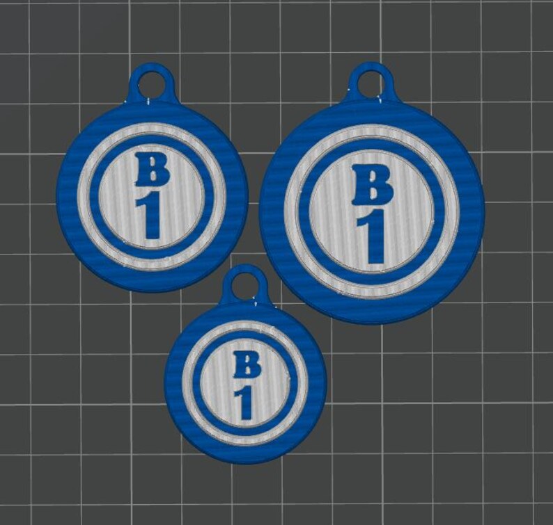 May include: Three blue and white circular pendants with a loop at the top for hanging. Each pendant has a white center with the letters "B" and the number "1" in blue. The pendants are different sizes.