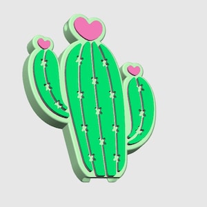 May include: A 3D-rendered cactus in shades of green and light green, with pink heart-shaped accents. The cactus has a textured appearance with vertical lines and small star-shaped details. The design is playful and whimsical.