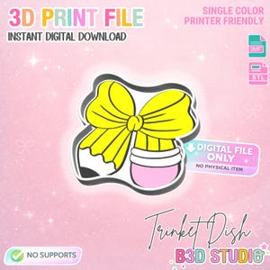 May include: A digital file for a trinket dish, featuring a yellow bow and pencil design. The image includes the text "3D Print File" and "Instant Digital Download". It is single color and printer friendly. The design is from B3D Studio.