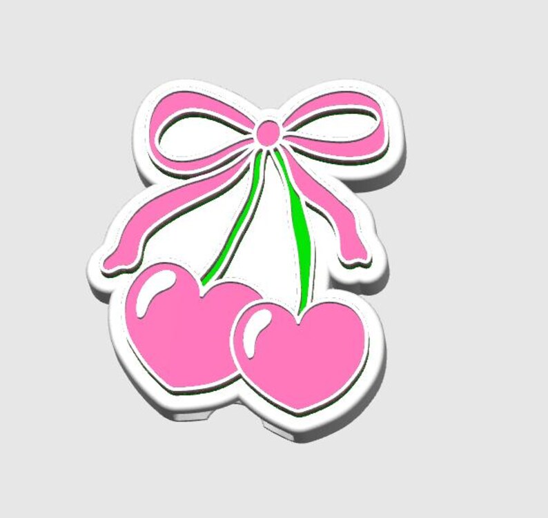 May include: A sticker featuring a pair of pink heart-shaped cherries with a pink bow and green stems. The design has a white outline and a subtle shadow, giving it a 3D effect. The background is a solid light gray.