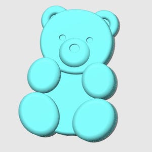 May include: A light blue teddy bear figurine. The bear has a round head with small ears, two small eyes, and a circular nose. It has four round limbs and is sitting upright. The bear is a solid color and has a smooth texture.