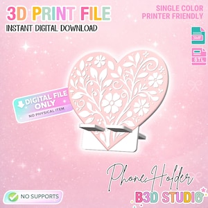 May include: A pink heart-shaped phone holder with a floral design, a digital file for 3D printing. The image includes the text "3D Print File" and "Instant Digital Download". The design is single color and printer friendly.