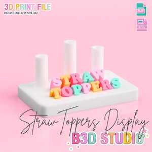 May include: A white display stand with three cylindrical posts and colourful letters spelling "STRAW TOPPERS". The text "3D PRINT FILE" and "INSTANT DIGITAL DOWNLOAD" are at the top. The words "Straw Toppers Display" and "B3D STUDIO" are also visible.