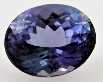 May include: A deep purple oval-shaped gemstone with a faceted cut.