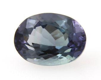 May include: A dark blue oval-shaped gemstone with a faceted cut.
