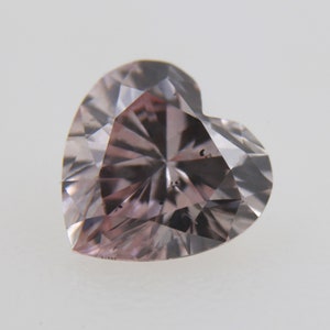 May include: A heart-shaped, light pink diamond with a faceted cut.