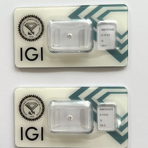 Könnte beinhalten: Zwei IGI-Diamant-Gutachten mit jeweils einem weißen Diamanten. Der obere Bericht zeigt einen 0,13 Karat Diamanten mit einer G-Farbe und VS1-Reinheit. Der untere Bericht zeigt einen 0,13 Karat Diamanten mit einer G-Farbe und VS2-Reinheit.