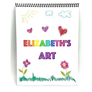 May include: A white spiral bound sketchbook with the words "ELIZABETH'S ART" written in rainbow colors. The sketchbook has drawings of a sun, clouds, hearts, flowers, and grass.