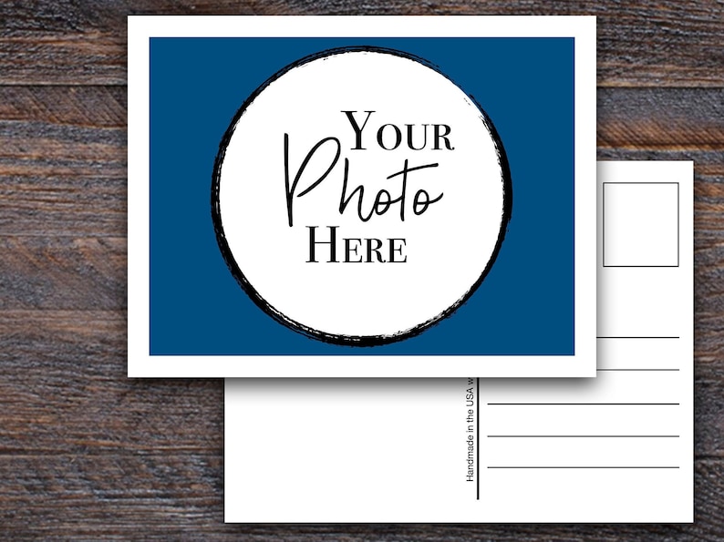 May include: A blank postcard with a blue background and a white circle in the centre. The circle has a black outline and the text "YOUR Photo HERE" in black lettering.