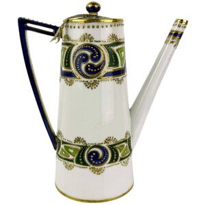 May include: A white porcelain teapot with a blue and green geometric design. The teapot has a gold trim and a lid with a knob.