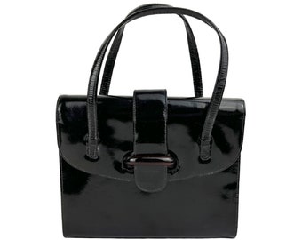 May include: A black patent leather handbag with a top handle and a single clasp closure.