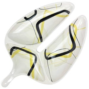 May include: A white ceramic serving dish with three sections. The dish has a black and yellow abstract design.