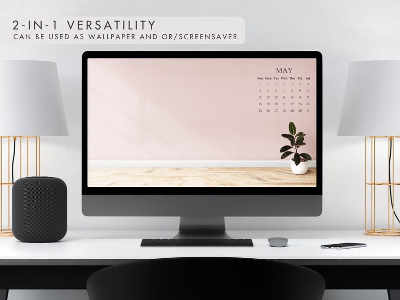May include: A desktop computer displays a May calendar wallpaper with a pink wall and wooden floor design. A small potted plant sits on the desktop. The text "2-IN-1 VERSATILITY" and "CAN BE USED AS WALLPAPER AND OR/SCREENSAVER" are at the top.
