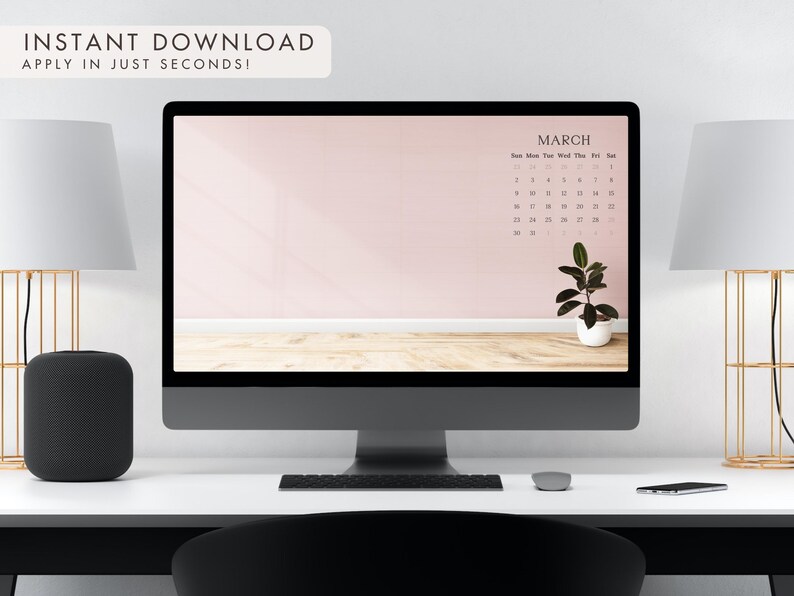 May include: A desktop computer displays a March calendar on a pink background with a small potted plant. The text "INSTANT DOWNLOAD APPLY IN JUST SECONDS!" is at the top. The computer sits on a white desk with lamps and a speaker.