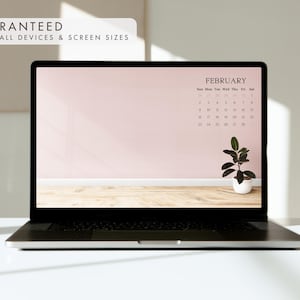 May include: A laptop displays a February calendar on a pink background with a small potted plant. The text "GUARANTEED TO FIT ALL DEVICES & SCREEN SIZES" is in the upper left corner. The laptop is on a white surface.