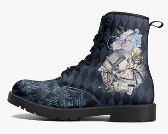 May include: A black lace-up ankle boot featuring a dark blue and black diamond pattern. The side displays an illustration of a girl, a character in a top hat, a clock, and a butterfly. The text "We're all Mad Here" is printed on the lower front.
