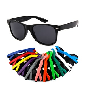 May include: Black sunglasses with a variety of coloured replacement arms. The arms are in a rainbow of colours, including red, orange, yellow, green, blue, purple, pink, and white.