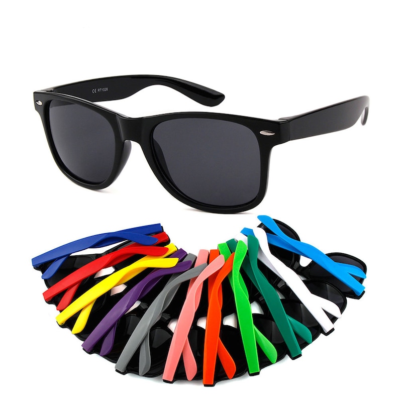 May include: Black sunglasses with a variety of coloured replacement arms. The arms are in a rainbow of colours, including red, orange, yellow, green, blue, purple, pink, and white.