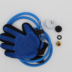 May include: A blue pet grooming glove with a black interior and textured surface, connected to a blue hose. Additional components include a white cap, black and gold fittings, and a black washer. The items are arranged on a white background.