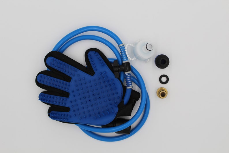 May include: A blue pet grooming glove with a black interior and textured surface, connected to a blue hose. Additional components include a white cap, black and gold fittings, and a black washer. The items are arranged on a white background.