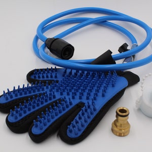 May include: A blue pet grooming glove with silicone bristles, a blue hose, a white bottle, and a brass fitting. The glove is black on the back and has a loop for hanging. The hose is coiled.