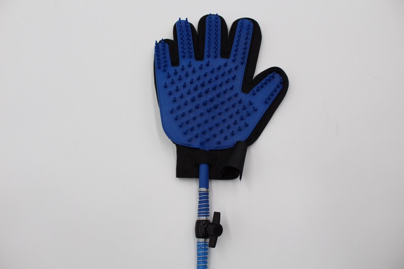 May include: Blue pet grooming glove with rubber bristles. The glove is attached to a blue hose with a black valve. The glove is black around the wrist area.