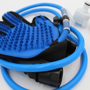 May include: A blue pet grooming glove with silicone bristles, a blue hose, and various connector pieces. The glove has a black mesh backing. Additional components include a white filter and black and brass connectors.