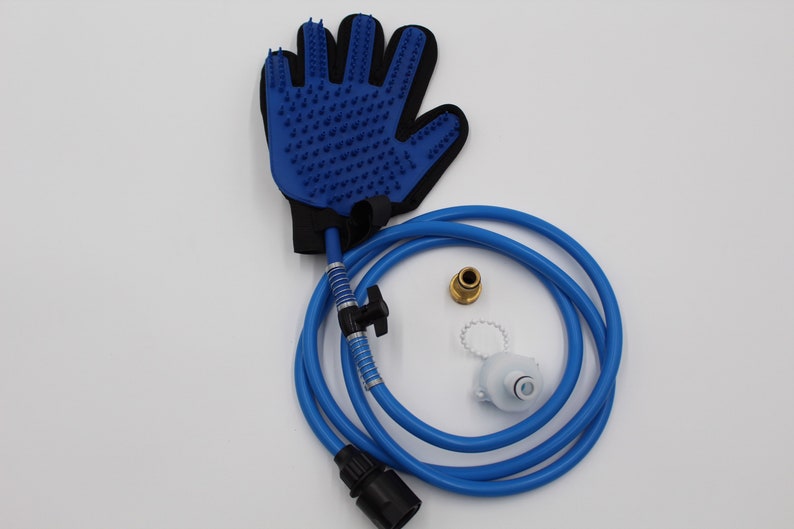 May include: A blue pet grooming glove with rubber bristles, connected to a blue hose with a black connector. Additional components include a brass fitting and a white plastic piece. The items are designed for pet care.