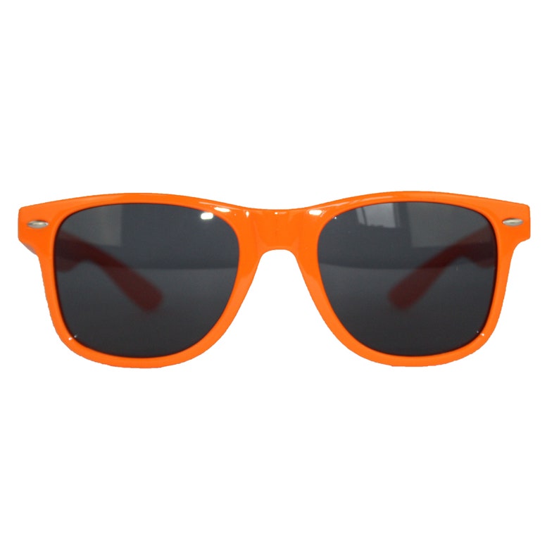 May include: Orange plastic sunglasses with black lenses.