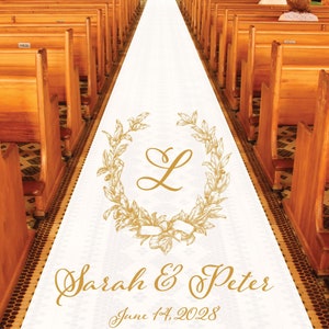May include: A white wedding aisle runner with gold floral wreath and initial "L" design. The names "Sarah & Peter" and the date "June 14, 2028" are printed in gold script. Wooden church pews line the sides.