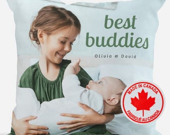 May include: A throw pillow featuring a photograph of two children, a girl holding a baby, with the text "best buddies Olivia & David" and a red circle with a maple leaf and the text "Made in Canada Fabriqué au Canada".