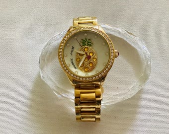 Vintage gold -tone Betsey Johnson Pineapple Watch with a crystal-accented bezel and mother-of-pearl dial.
